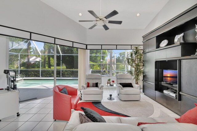 living room with light tile patterned floors, ceiling fan, and vaulted ceiling