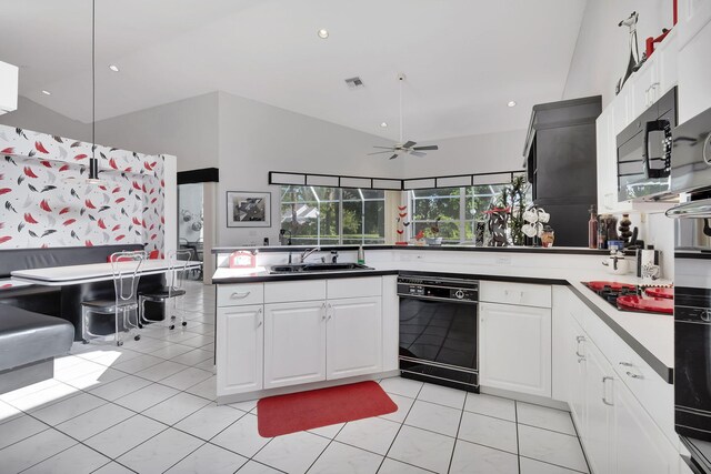 kitchen featuring black appliances, kitchen peninsula, light tile patterned floors, white cabinetry, and ceiling fan