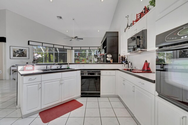 kitchen featuring sink, white cabinetry, black appliances, and kitchen peninsula