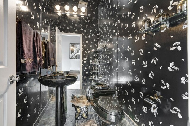 bathroom featuring tile patterned flooring and toilet