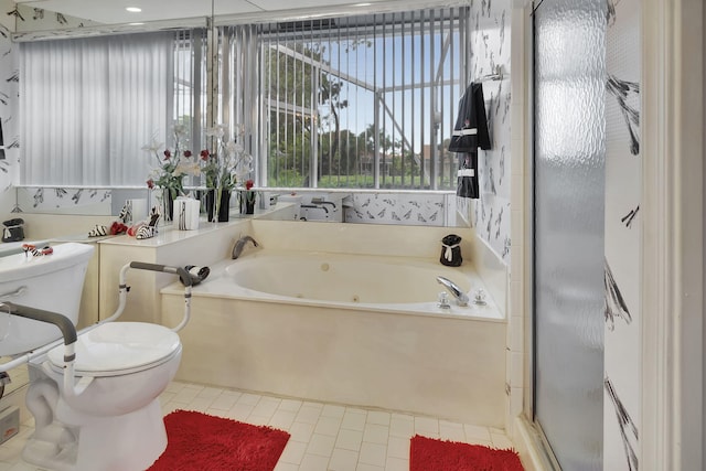 bathroom featuring a tub, tile patterned floors, and toilet