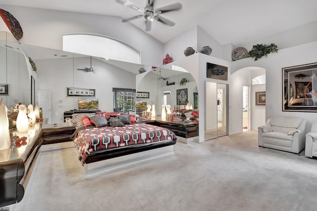 bedroom featuring high vaulted ceiling, light carpet, and ceiling fan