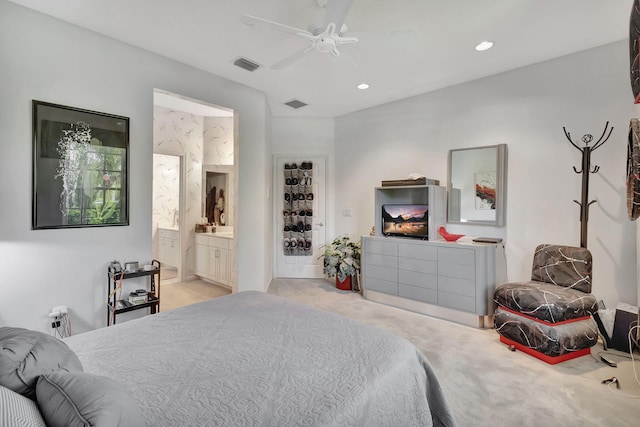 carpeted bedroom featuring ensuite bathroom and ceiling fan