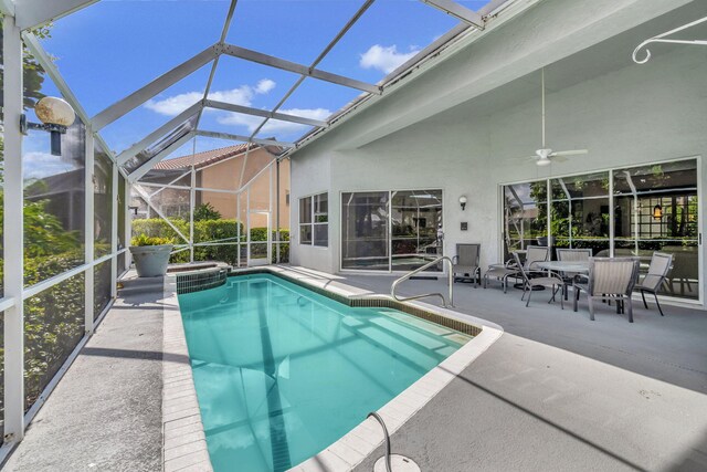 view of swimming pool with a patio, ceiling fan, and a lanai