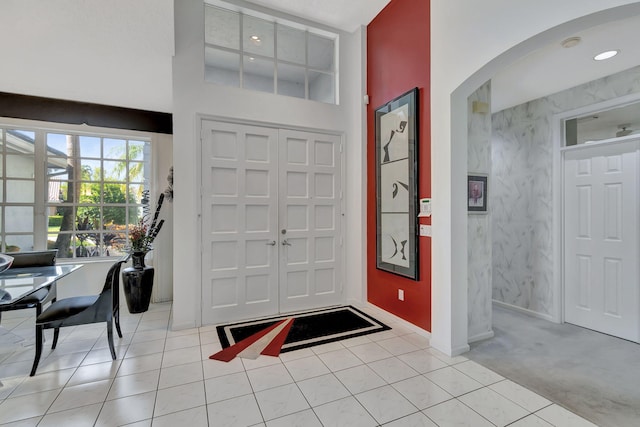 tiled entryway with a high ceiling