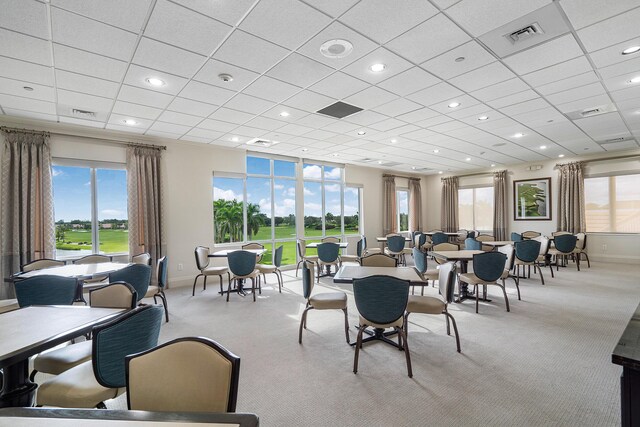 dining room with a paneled ceiling and plenty of natural light