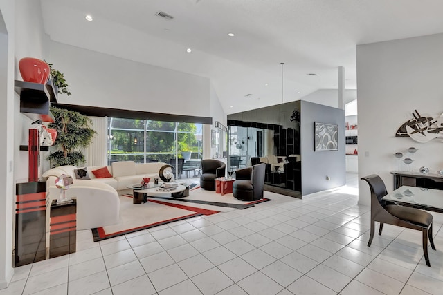 living room with light tile patterned flooring and high vaulted ceiling