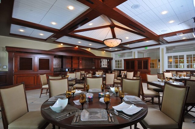 dining area with beamed ceiling and coffered ceiling