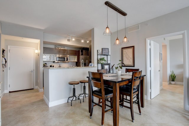 dining room featuring track lighting