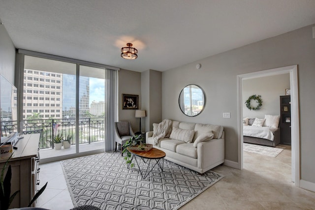 living room with a wall of windows and light tile patterned floors