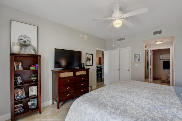 tiled bedroom featuring ceiling fan, connected bathroom, and a closet