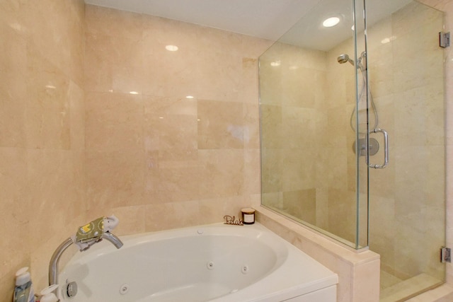 bathroom featuring separate shower and tub and tile walls