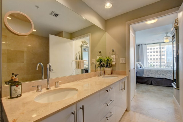 bathroom with tile patterned floors, vanity, and ceiling fan