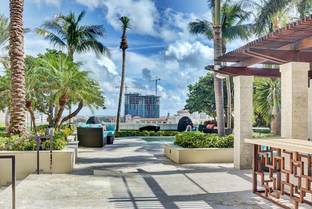 view of property's community with a pergola, outdoor lounge area, and a patio area