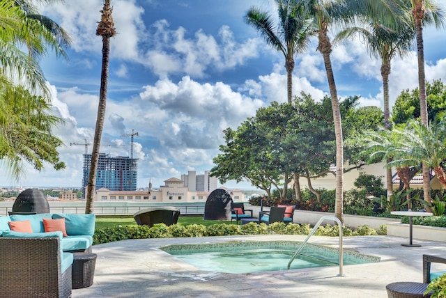 view of pool with an outdoor living space, a community hot tub, and a patio area