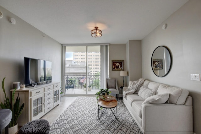 living room with expansive windows and light tile patterned floors