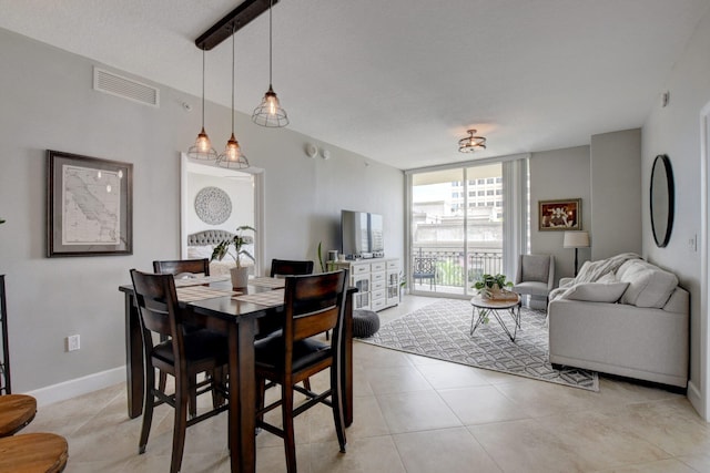 tiled dining space featuring floor to ceiling windows