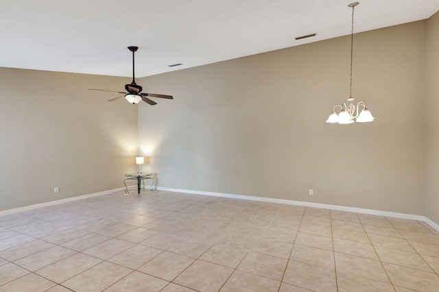 spare room featuring ceiling fan with notable chandelier and light tile patterned floors