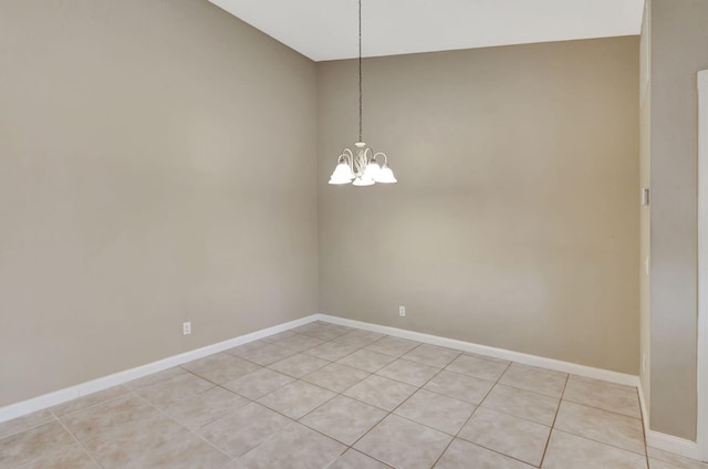 unfurnished room featuring a notable chandelier, light tile patterned floors, and vaulted ceiling