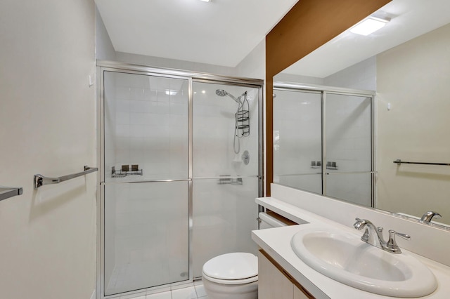 bathroom with tile patterned floors, a shower with door, vanity, and toilet