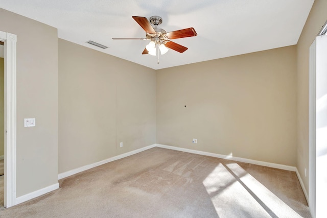 unfurnished room with ceiling fan and light colored carpet