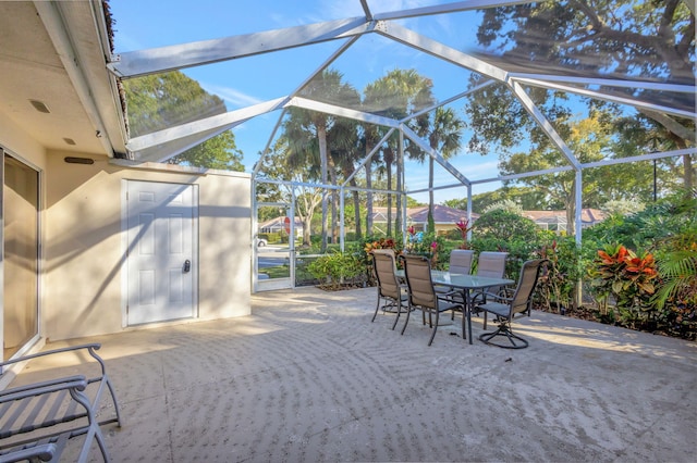 view of patio featuring glass enclosure