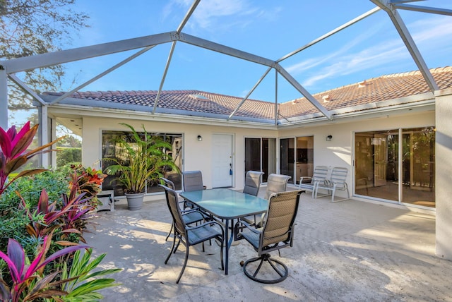 view of patio with glass enclosure