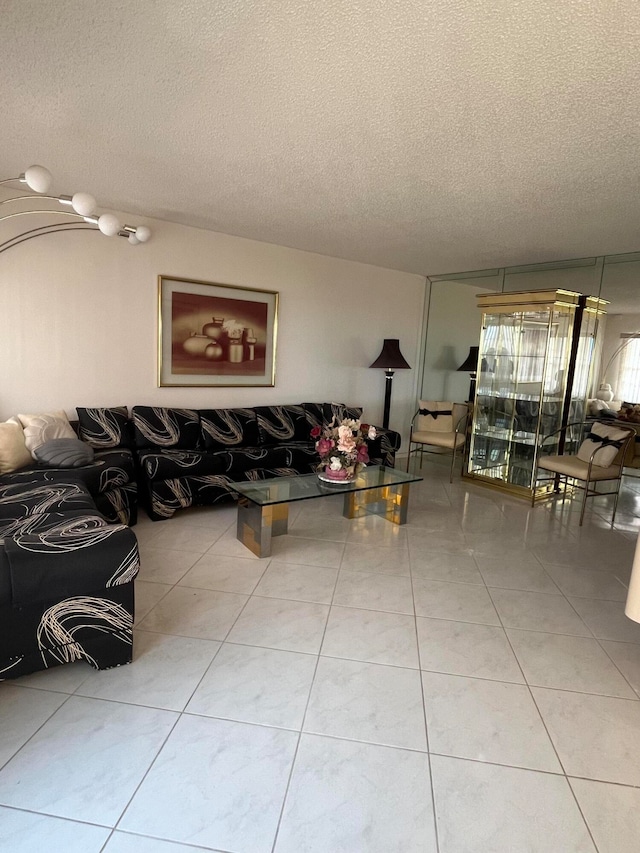 living room featuring light tile patterned flooring and a textured ceiling