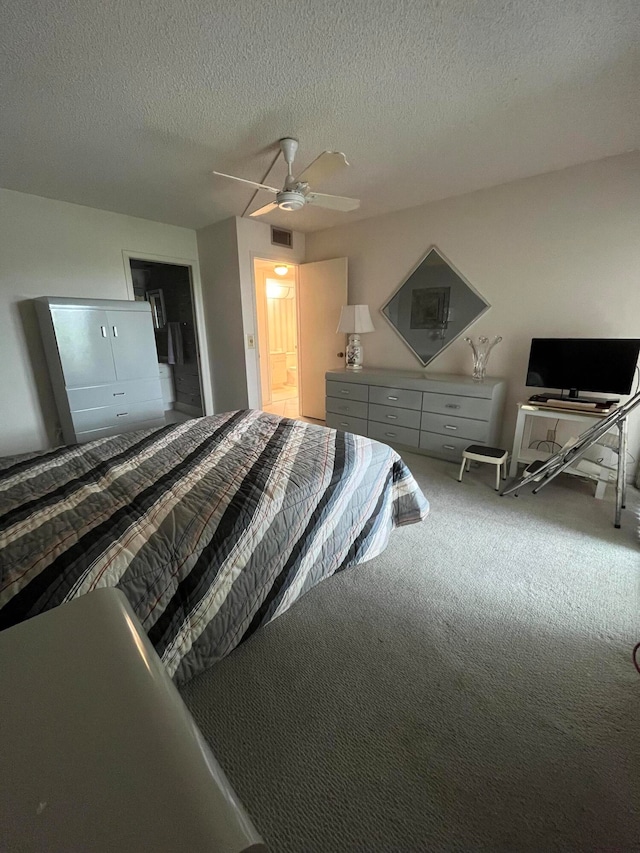 bedroom featuring carpet floors, a textured ceiling, and ceiling fan