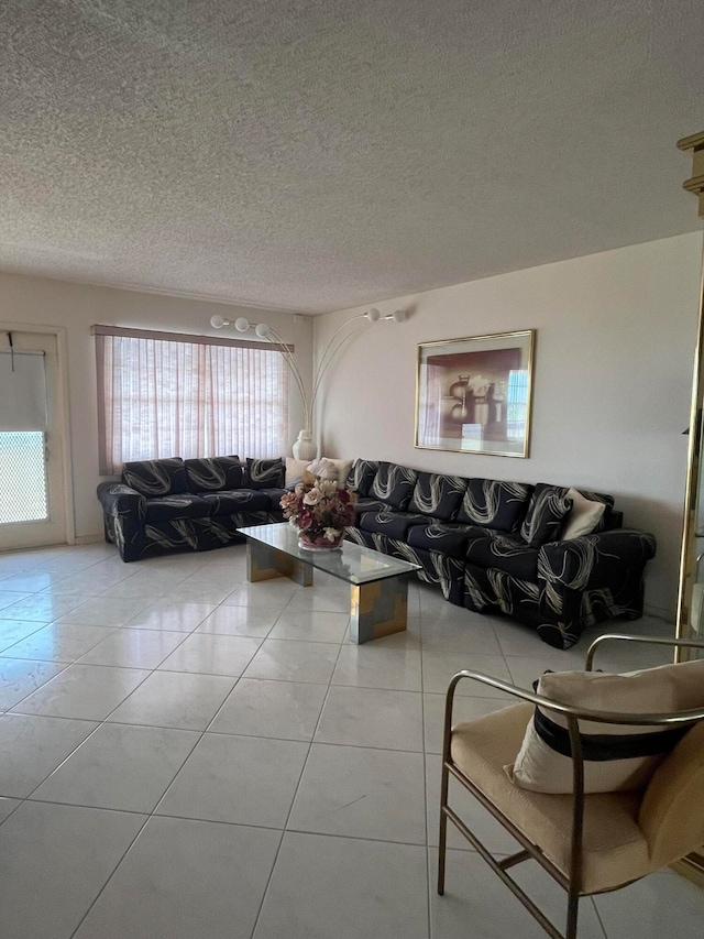 tiled living room featuring a textured ceiling