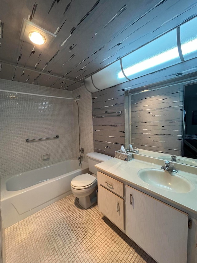 full bathroom with tile patterned flooring, toilet, vanity, and tiled shower / bath