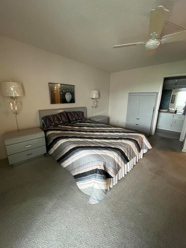 bedroom with carpet flooring, a textured ceiling, and ceiling fan