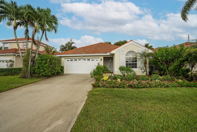 mediterranean / spanish home featuring a front yard and a garage