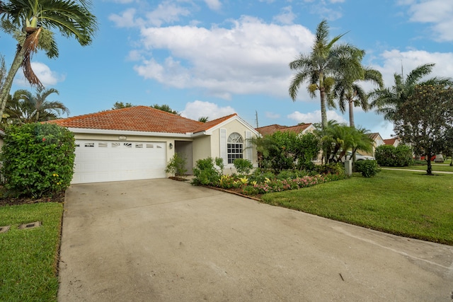 mediterranean / spanish-style house with a garage and a front yard