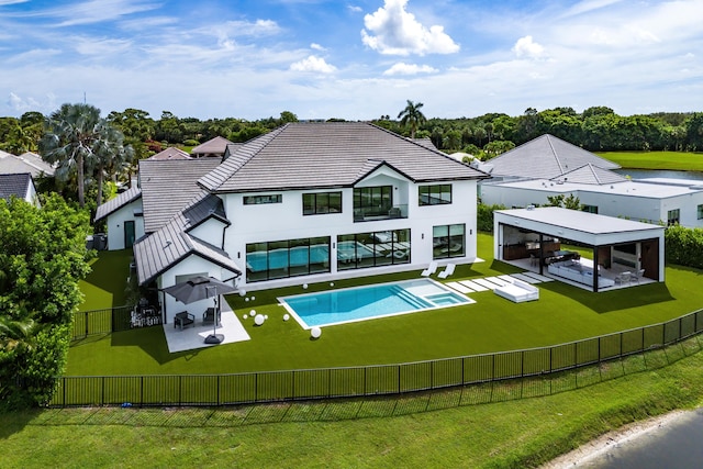 view of swimming pool featuring outdoor lounge area, a patio, a lawn, and a gazebo