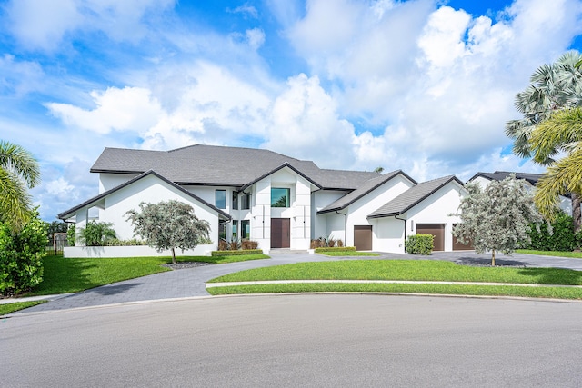 view of front of home with a garage and a front yard