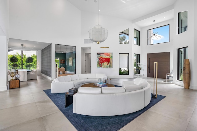 tiled living room with a wealth of natural light and a high ceiling