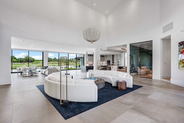 living room with light tile patterned floors and a high ceiling