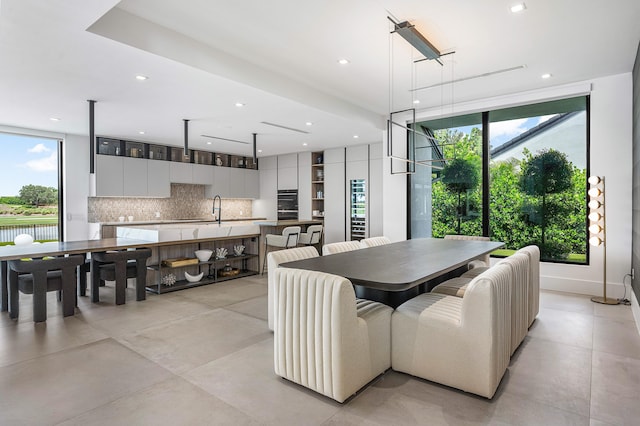 dining space featuring light tile patterned flooring and sink