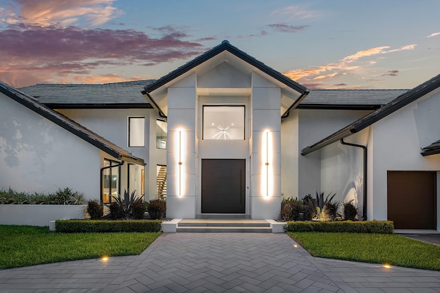 contemporary house with a garage and a yard