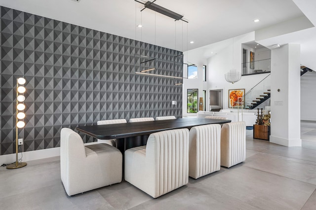 dining space with a towering ceiling