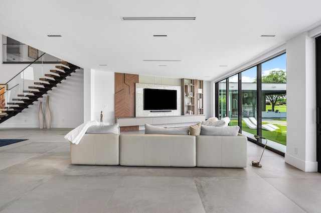 living room featuring light tile patterned floors and expansive windows