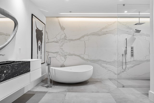 bathroom featuring a tile shower, tile patterned flooring, and tile walls