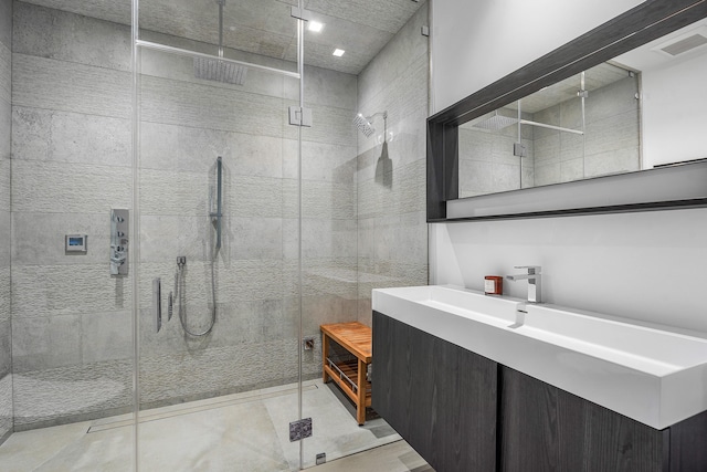 bathroom featuring walk in shower, tile patterned flooring, and vanity