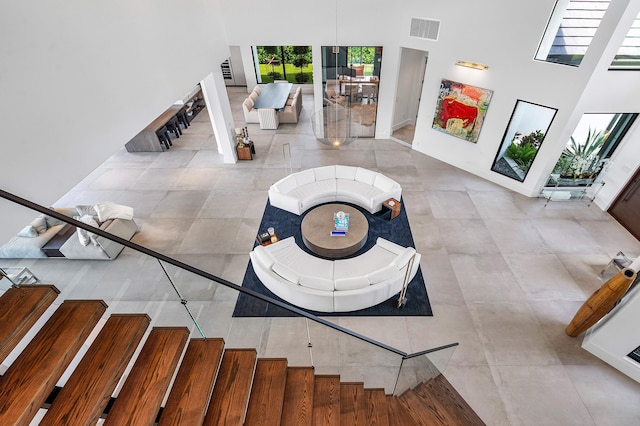 interior space with a towering ceiling and tile patterned floors