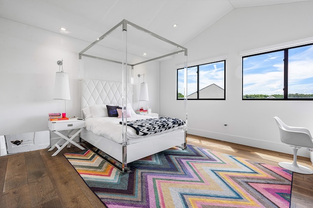 bedroom with lofted ceiling and hardwood / wood-style floors