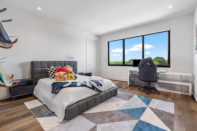 bedroom with dark wood-type flooring