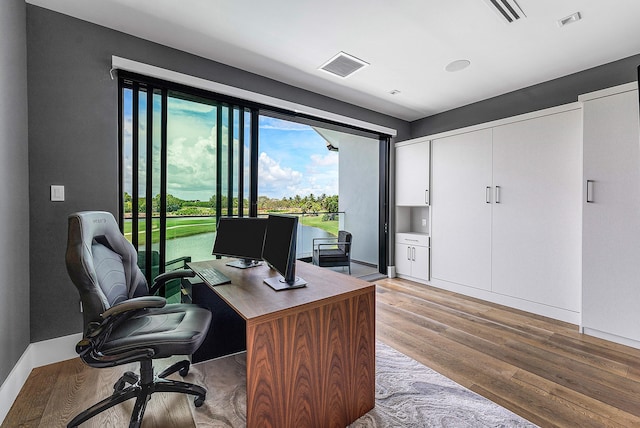 office with light hardwood / wood-style flooring