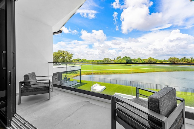 balcony with a water view and an outdoor living space