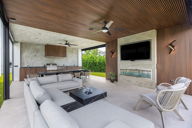 view of patio / terrace featuring sink, ceiling fan, a grill, and an outdoor hangout area